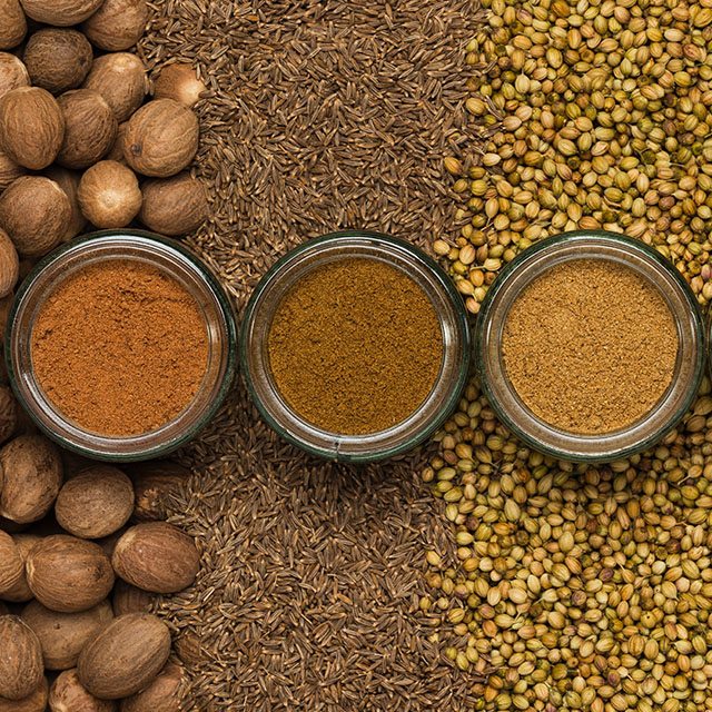 Close up shot of tropical spices in three glass containers